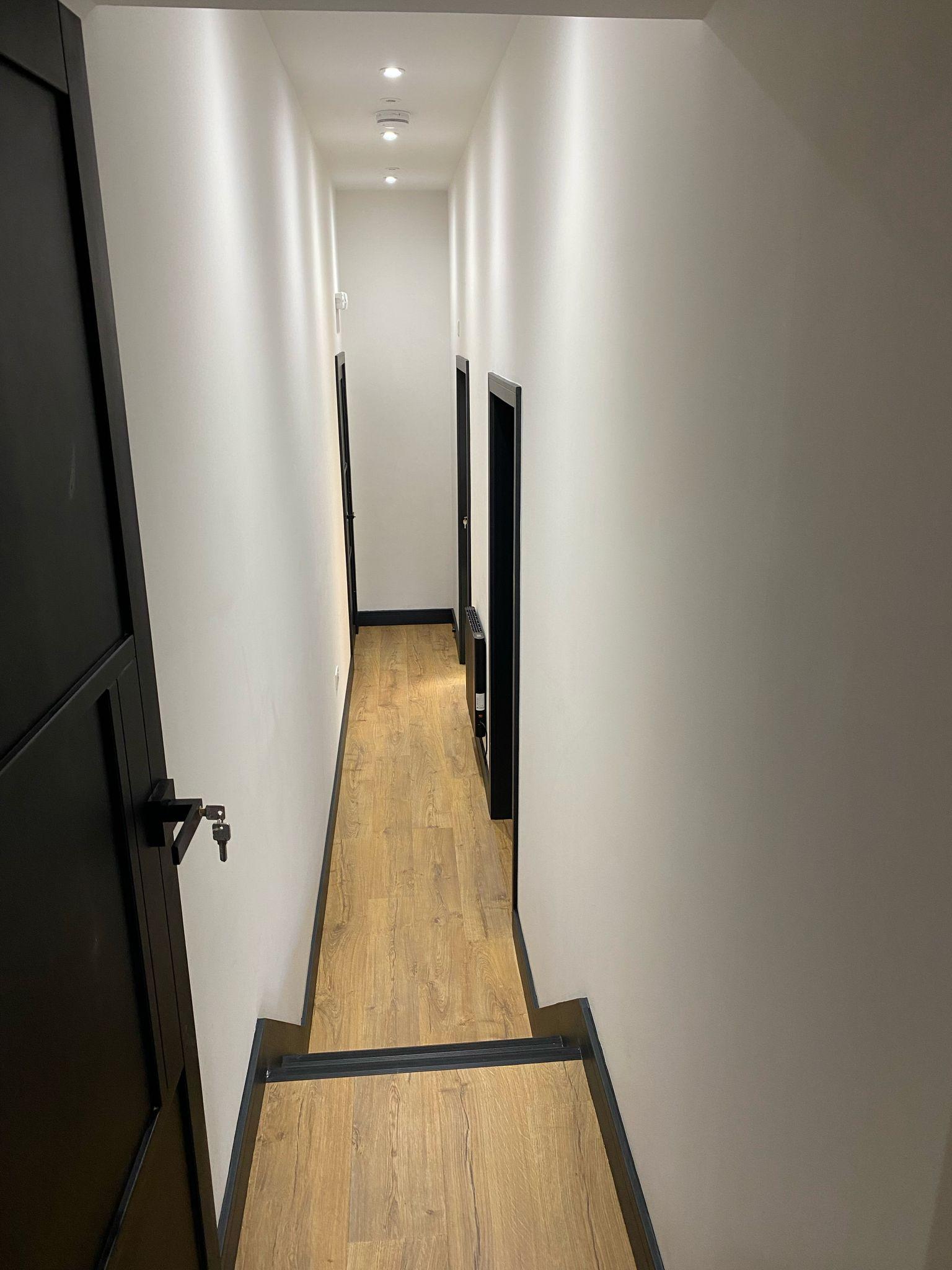 Engineered oak flooring and dark doors in a finished hallway, Swansea
